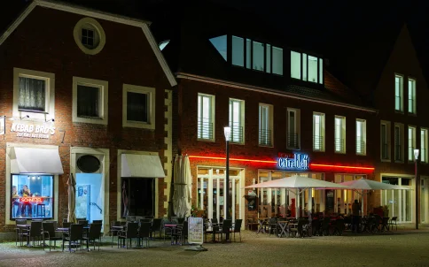 Restaurants and shops lit up at night in McHenry